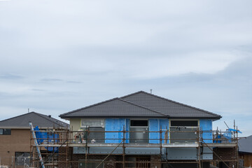 A two-story house is under construction in Melbourne's new suburban neighborhood in Tarneit, VIC,...