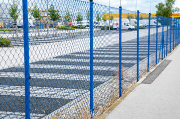 Blue steel wire mesh fence around the protected area. Restricted area protection.