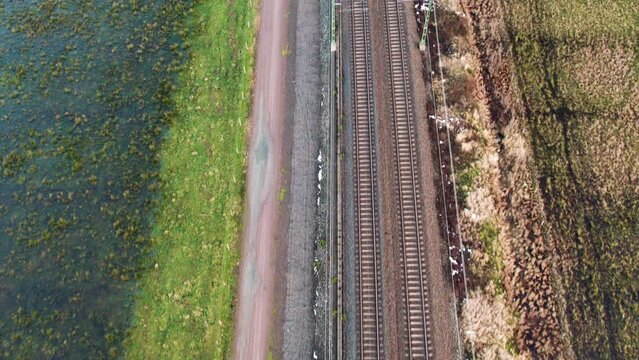 Parallel Railway Tracks Next to E45 in Gothenburg, Natural Surroundings, Daytime, Aerial View