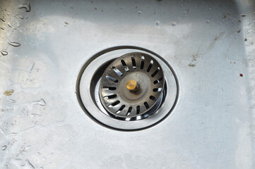 close-up shot of a clean sink hole, every detail is magnified, revealing the meticulous care put into maintaining a spotless kitchen environment.