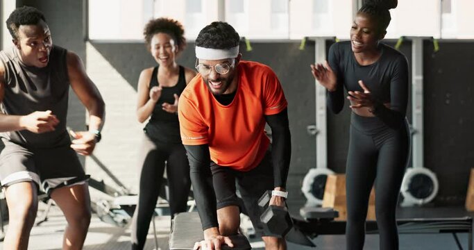 Fitness, group and motivation or celebration for workout success, training and funny nerd with weak arms in gym. People or friends with yes, fist and clapping or applause for support of man or comedy
