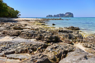 Rocky coast on the background of karst mountains, sea and boats