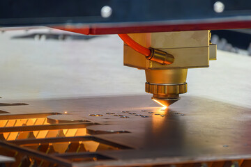 The fiber laser cutting machine  cut the metal plate with the sparkling light.