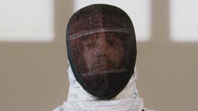 Person moving while wearing a fencing mask