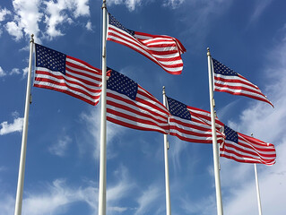Fototapeta premium Images of American flags fluttering in the wind evoke a sense of patriotism and remembrance on Memorial Day.