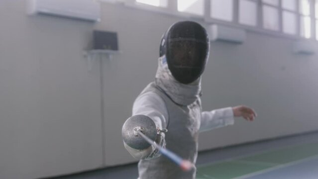 Person lunging their sword straight at the camera