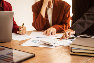 Analyzing startup group meetings to offer advice and make decisions. We assess discussions, offer insights, and assist in reaching conclusions for better business outcomes, hands close up at desk.