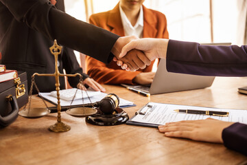 Shaking hands, Lawyers offer legal guidance, stand for clients in court, and aid with legal...