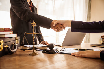 Shaking hands, Lawyers offer legal guidance, stand for clients in court, and aid with legal...