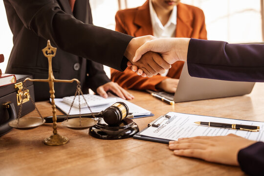 Shaking hands, Lawyers offer legal guidance, stand for clients in court, and aid with legal paperwork. analyze laws to safeguard clients' rights and interests, fair representation and justice.