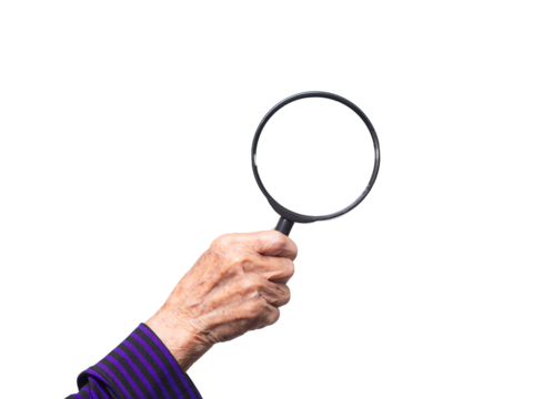 Close-up of an old woman's hand holding a magnifying glass against a transparent background. - Powered by Adobe