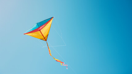 Colorful kite soaring against a clear blue sky, symbolizing freedom and joy.
