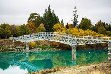 Lake tekapo autumn bridge near The Church of Good Shepherd in a cloudy day