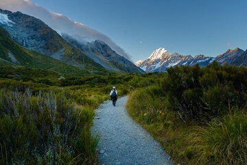 Female hiker in Mount Cook mountain valley hiking trail in the evening, New Zealand