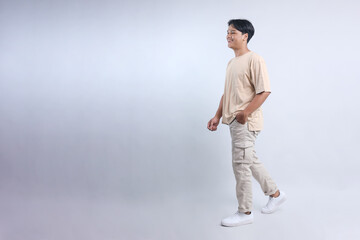 Full Length of Young Man In Casual Style Walking to The Side Isolated on White Background 