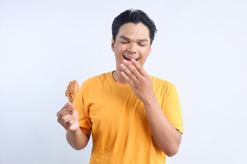 Young Asian Man Feeling Happy to Eat Fried Chicken  