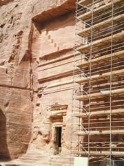 The remains of facade of one of Nabatean tombs in historical center of Petra in the Wadi Musa city...