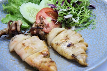 Grilled squids or 'Cumi Bakar' is a sweet and tangy seafood dish that is often sold as street food...