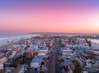 Aerial view of colorful sunrise sky over Mission Beach San Diego with residential vacation homes,...