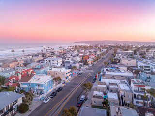 Aerial view of colorful sunrise sky over Mission Beach San Diego with residential vacation homes,...