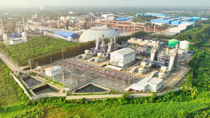 A Combined-Cycle Power Plant efficiently generates electricity by utilizing both gas and steam turbines, harnessing waste heat for enhanced energy production. Aerial view. 
