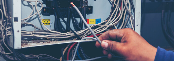 Banner Electrical mechanic technician check wire electric cabinet. Inspector men hands working...