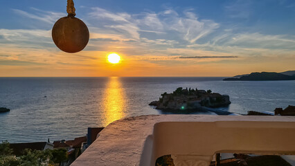 Balcony with hanging pillar in luxury hotel with scenic view on idyllic Sveti Stefan island at...
