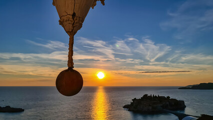 Balcony with hanging pillar in luxury hotel with scenic view on idyllic Sveti Stefan island at...