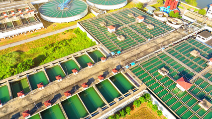 Fototapeta premium In a futuristic cityscape, a drone reveals a sleek, high-tech wastewater treatment plant, embodying innovation and sustainability, ensuring a clean, bright future for all. 