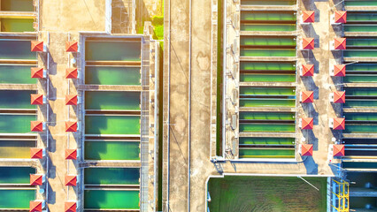 A mesmerizing aerial view of a wastewater treatment plant, resembling a high-tech marvel with advanced machinery and shimmering pools, a testament to environmental innovation.
