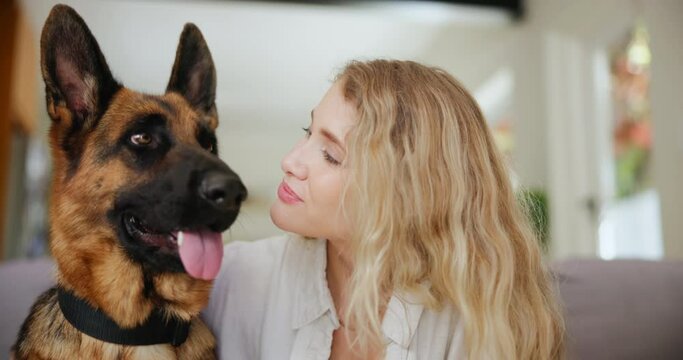 Woman, dog and kiss in home for love connection as animal owner for relax wellness, together or care. Female person, german shepherd and lounge bonding with pet for emotional support, house or happy