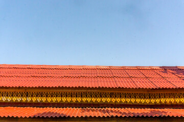 Orange Building Roof Against a Blue Sky Background. Horizontal Image with copy space.
