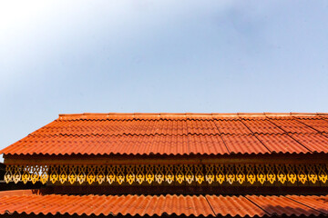 Orange Building Roof Against a Blue Sky Background. Horizontal Image with copy space.