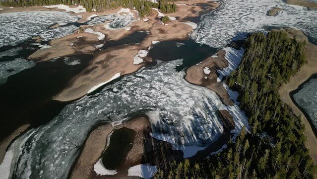 High angle aerial of frozen Lake Dillon in Silverthorne Colorado in springtime.