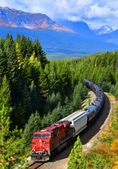 Long freight train moving along Bow river in Canadian Rockies ,Banff National Park, Canadian Rockies,Canada.