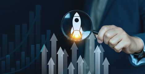 Concept focus on business growing, rising rocket icons on magnifying glass, Arrow rising.