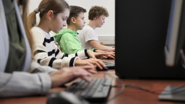 Schoolgirl using computer during computer sciene lesson in school.