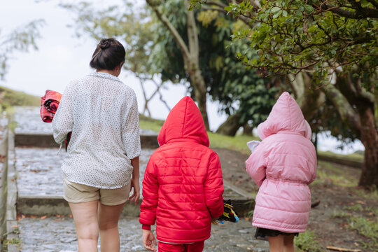 International Children Day. Tender Latina mother with her children on a family day outdoors. Single mom of two children. Nature and love.