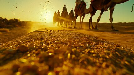 caravan of camels going beyond the horizon under the scorching rays of the sun. Low angle shooting. - Powered by Adobe