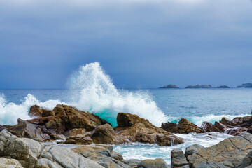 Pacific waves breaking on the rocks of the coast