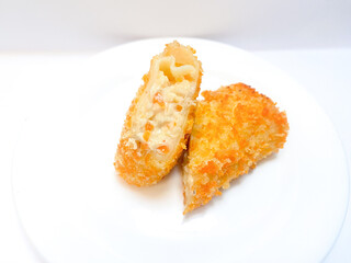 Spicy chicken risoles served on white plate