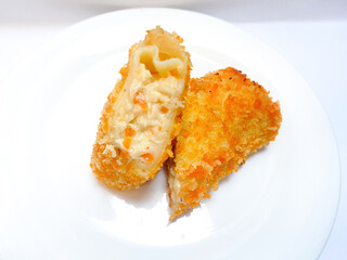 Spicy chicken risoles served on white plate