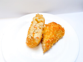 Spicy chicken risoles served on white plate