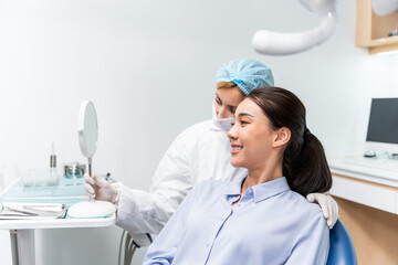 Caucasian dentist examine tooth for young girl at dental health clinic. 