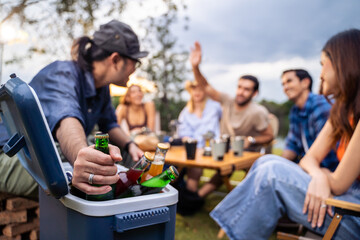 Group of diverse friend having outdoors camping party together in tent. 