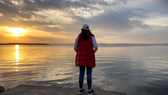 Woman Walking Along Lake Mendota at Sunset in Madison Wisconsin