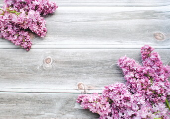 Lilac branches on a wooden background. Place for text, postcard, top view, copy, background