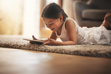 Female child, happy and playing with tablet on carpet for digital education, ebook and learning in...