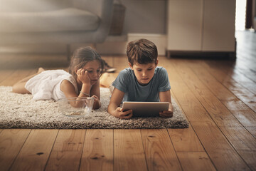 Kids, video and playing with technology on floor for digital education, ebook and learning in...