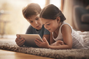 Children, movie and watching with tablet on floor for digital education, ebook and learning in...